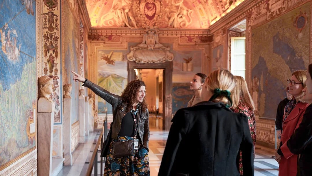 Guide leading tour group through Gallery of Maps, Vatican Museum.