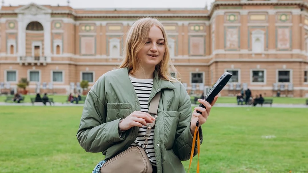 Tourist with audio guide in Vatican Gardens near Vatican Museums.