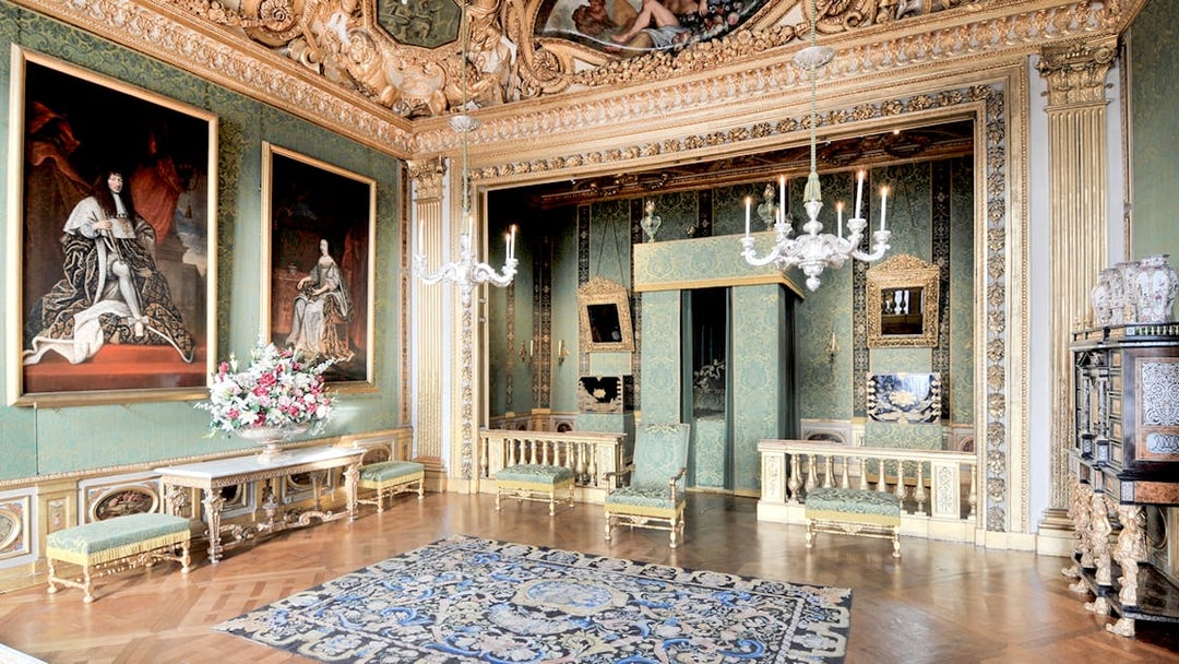 Vaux-le-Vicomte Castle interior with ornate decor and paintings on a day trip tour.