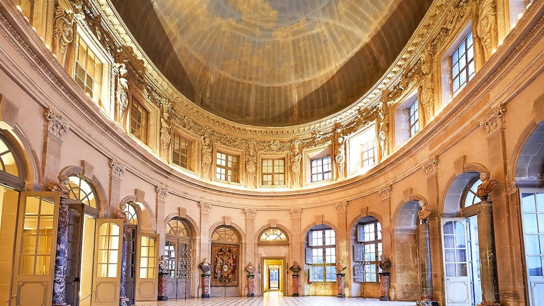 Vaux-le-Vicomte Castle interior with ornate dome and marble columns.