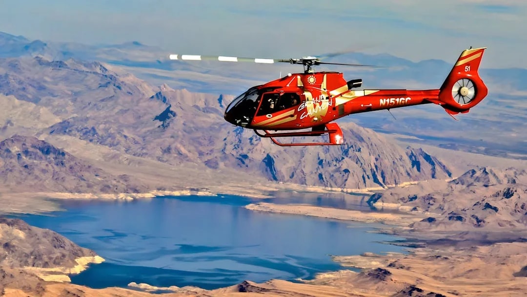 Helicopter flying over the Grand Canyon West Rim with Lake Mead in view.