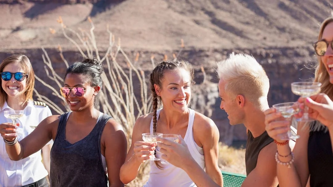 Group enjoying drinks at Grand Canyon after helicopter tour.