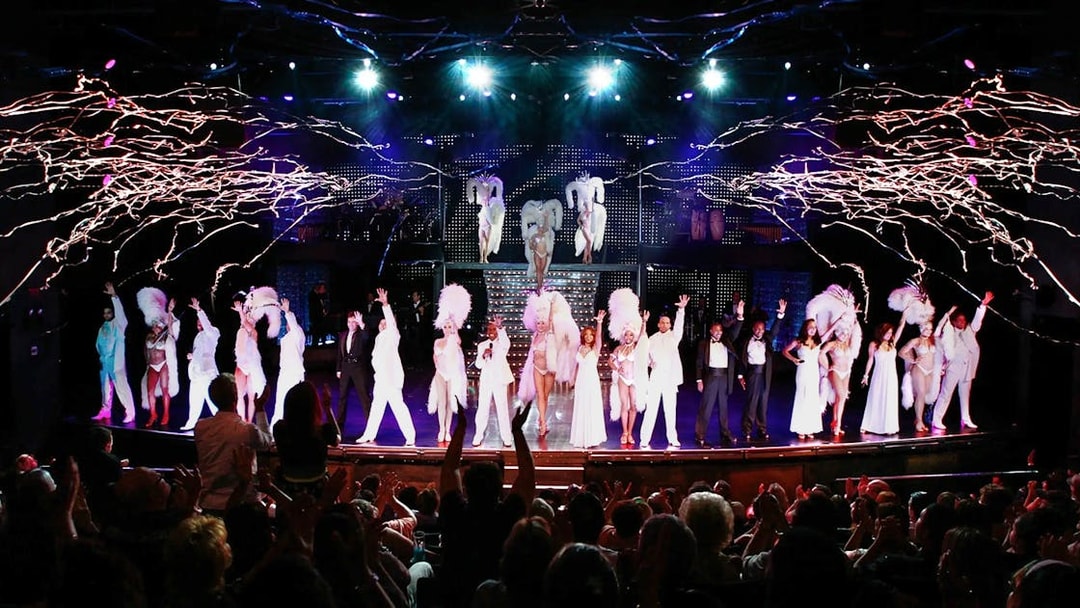 Performers on stage during VEGAS! The Show with audience applauding.