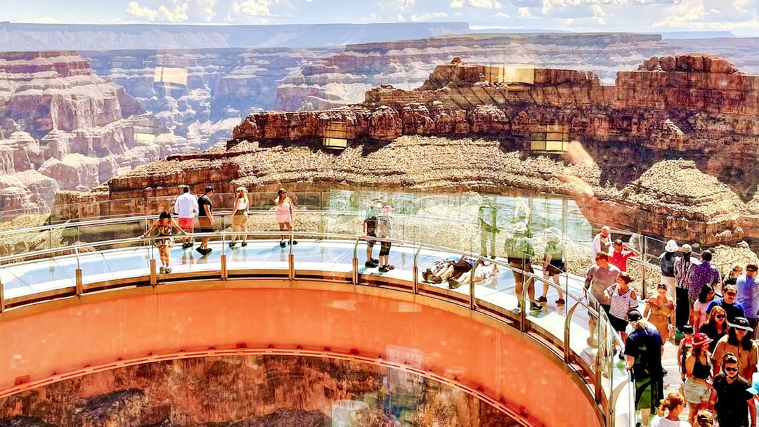 Visitors walking on the Grand Canyon Skywalk with canyon views in Arizona.