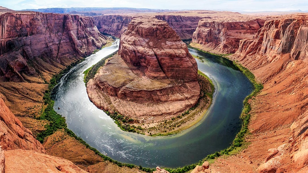 Horseshoe Bend in Arizona with the Colorado River curving around red rock formations.
