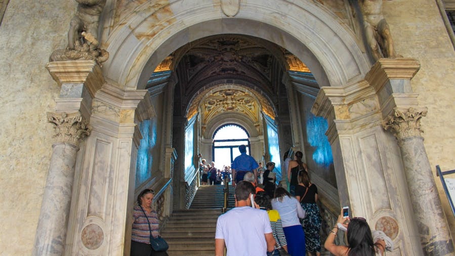 Visitors ascending the ornate staircase inside Doge’s Palace, Venice.
