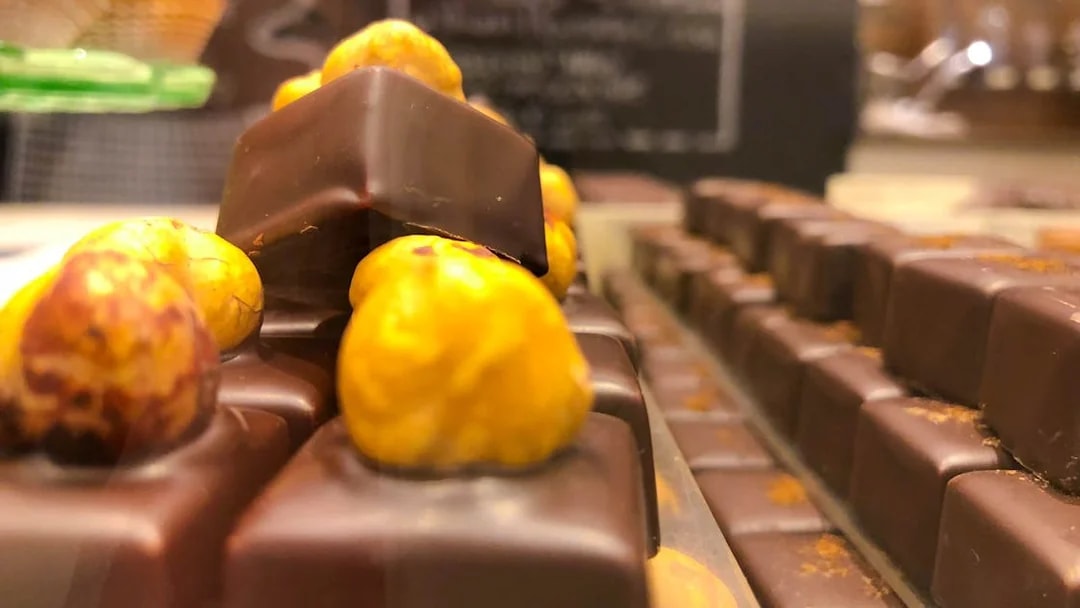 Chocolates with hazelnuts on display for tasting in a Venice shop.