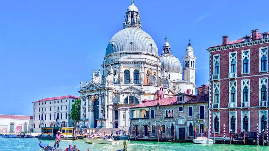 Gondola on Venice canal near Santa Maria della Salute basilica.