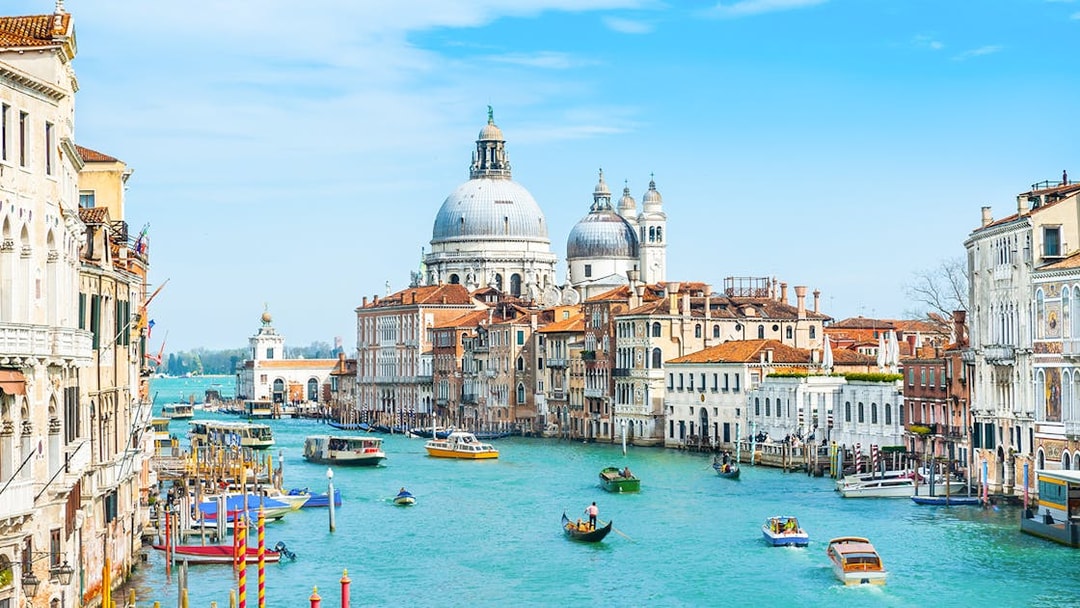 Grand Canal in Venice with gondolas and Santa Maria della Salute in the background.