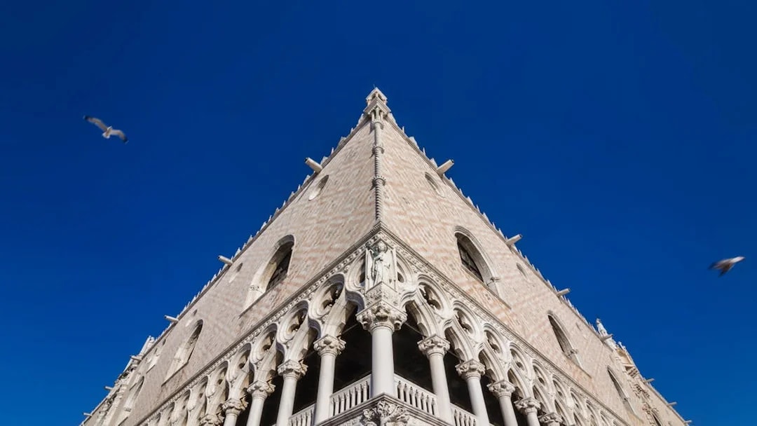 Doge's Palace facade in Venice under clear blue sky.