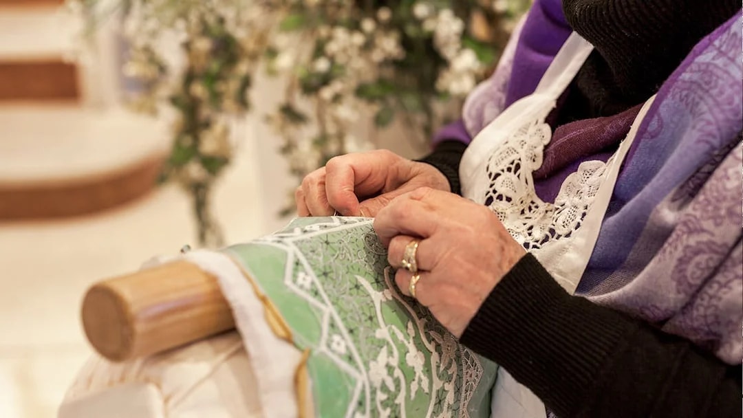 Lady embroidering lace on Burano, Venice tour.