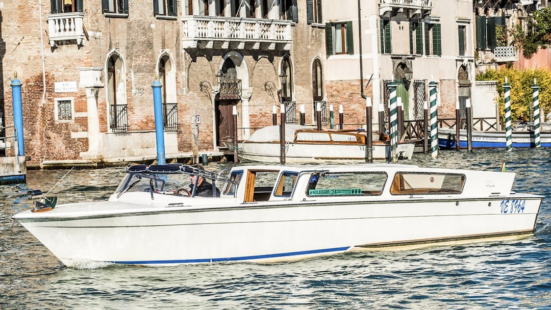 Private water taxi on Venice canal near historic buildings.