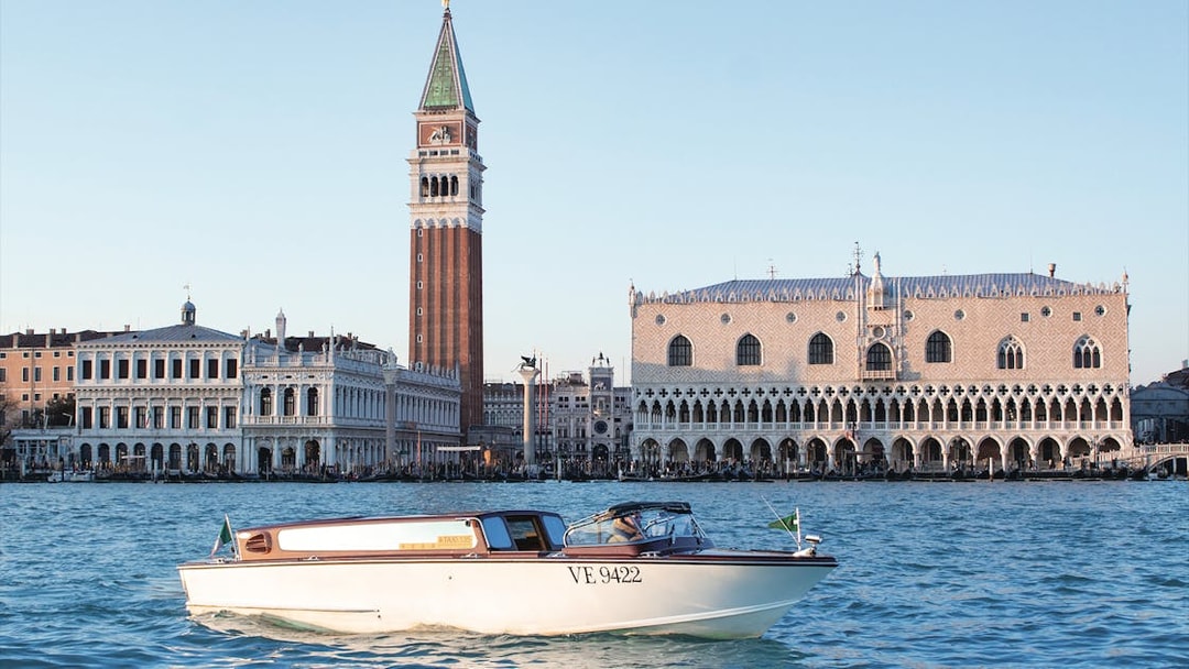 Water taxi on Grand Canal with Doge's Palace and Campanile in Venice.