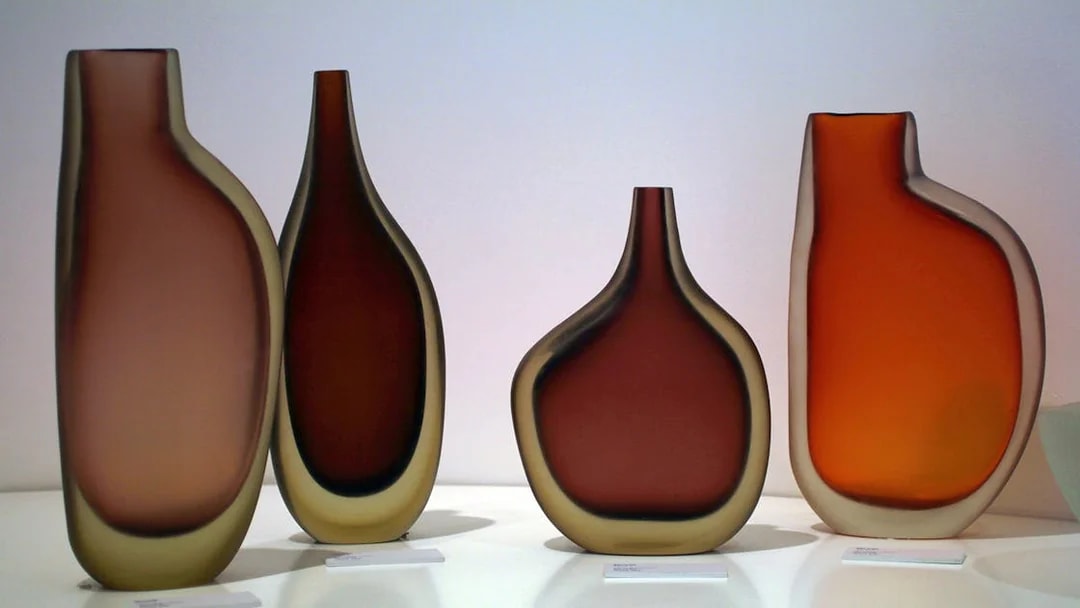 Venetian glass vases displayed in a museum, part of the Venice Museums Pass.