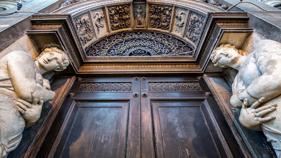 Entrance of Biblioteca Nazionale Marciana in Venice with ornate sculptures.