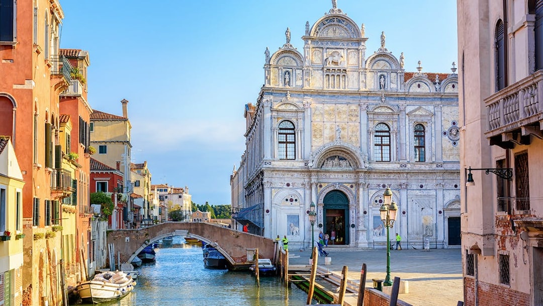Venice canal with historic buildings and bridge on a 2-hour walking tour.