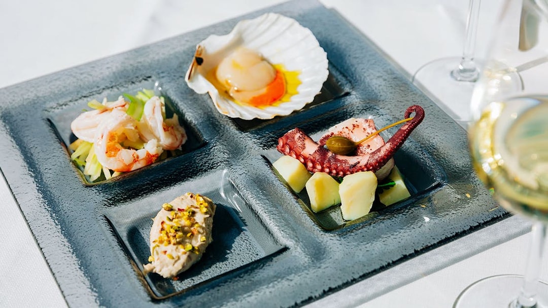 Venetian cicchetti platter with seafood and wine at illy Caffè, St. Mark's Square, Venice.