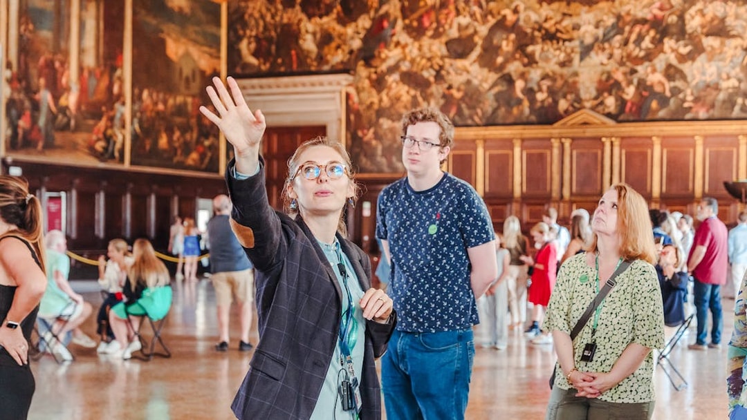 Tour guide explaining artwork during Doge's Palace guided tour in Venice.