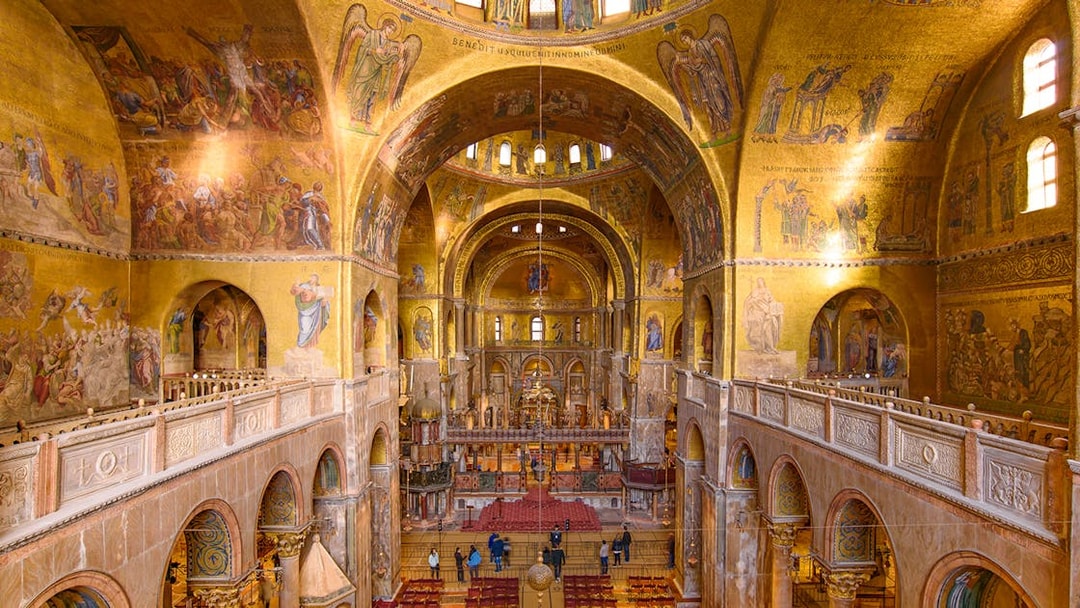 Interior of St. Mark's Basilica in Venice, showcasing ornate mosaics and architecture.
