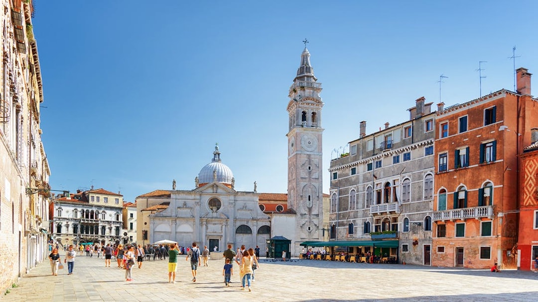 Venice walking tour with people in a piazza near San Giorgio dei Greci church.