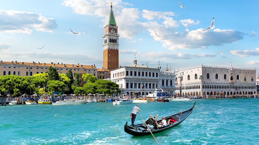 Gondola on Grand Canal with view of Doge's Palace and Bell Tower, Venice.