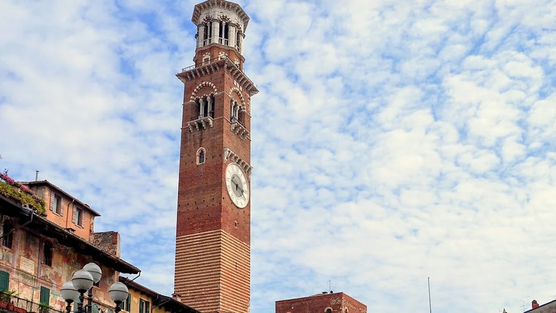 Torre dei Lamberti in Verona, Italy, under a cloudy sky.