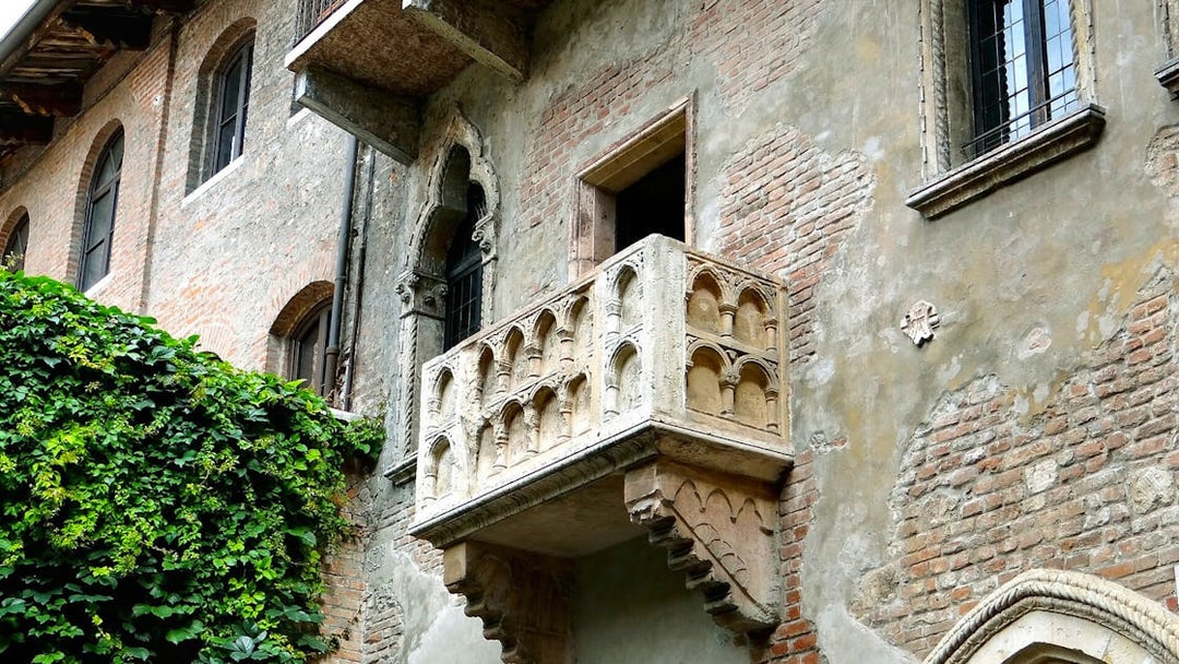 Juliet's balcony in Verona, Italy, covered in ivy, part of the self-guided audio tour.