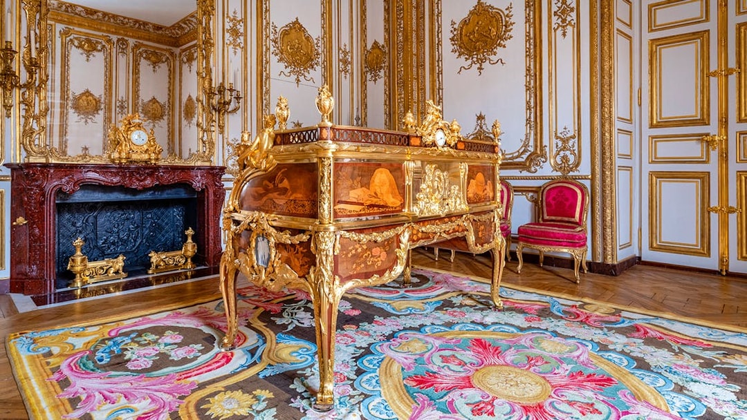 King’s Private Apartments in Versailles Palace with ornate desk and gilded decor.