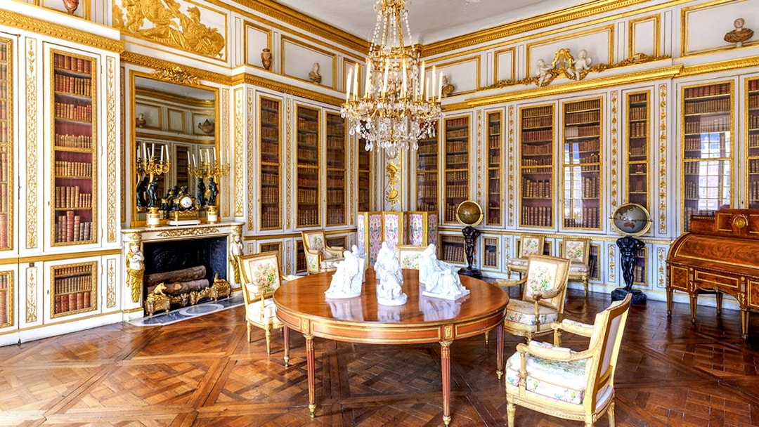 Versailles Palace King's Private Apartments library with ornate decor and chandelier.