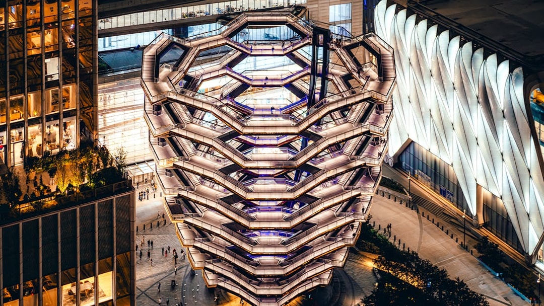 Vessel structure in New York City illuminated at night, viewed from above.