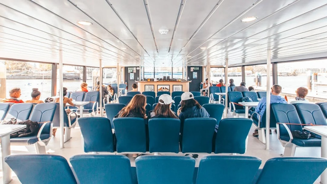 Interior seating area of the Salish Sea Eclipse catamaran with passengers enjoying the view.