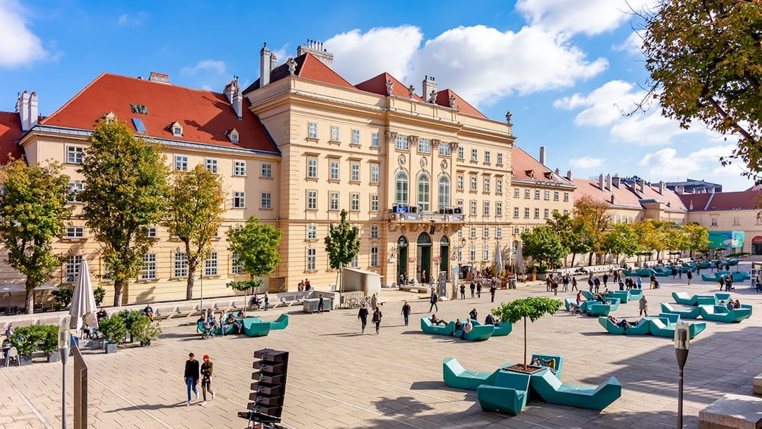 Courtyard of MuseumsQuartier Vienna with people and modern seating.