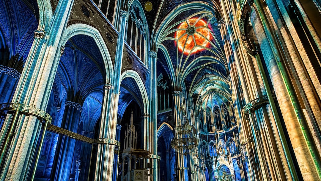 Votivkirche interior with colorful light projections, Vienna.