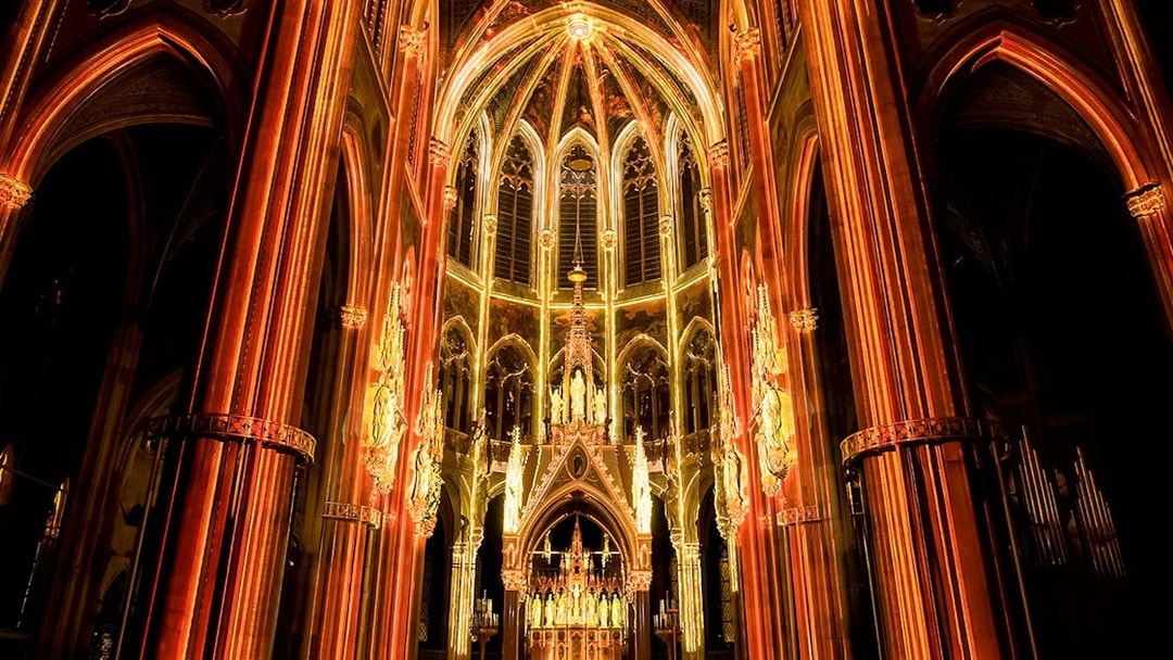 Votivkirche interior illuminated during Light of Creation event in Vienna.