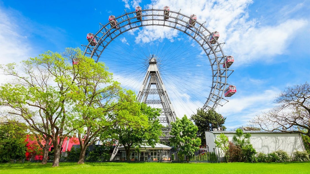 Vienna Ferris wheel in Prater Park on a sunny day, part of a self-guided audio tour.