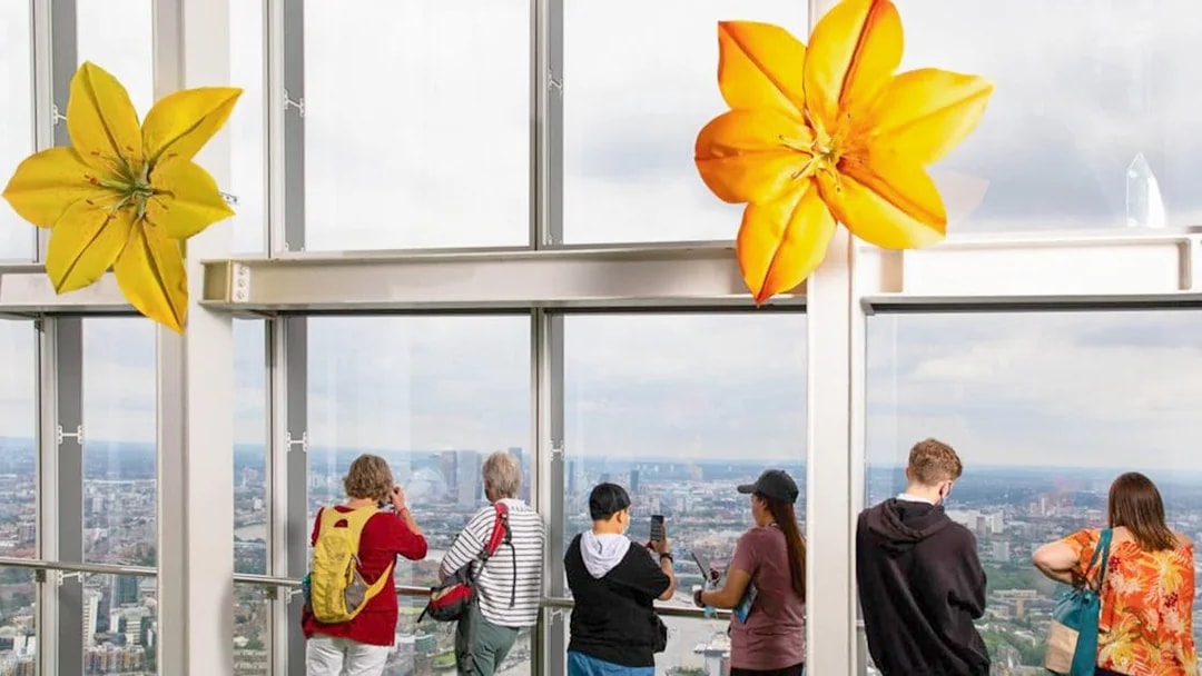 Visitors enjoying the London skyline from The Shard's observation deck.