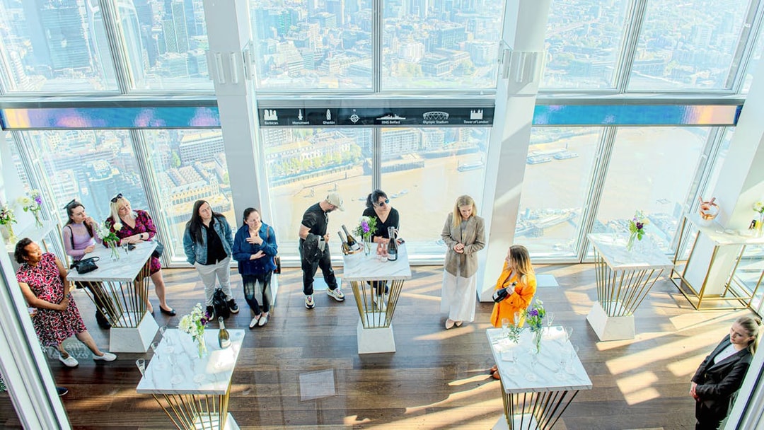 Guests enjoying champagne with a view of London from The Shard.