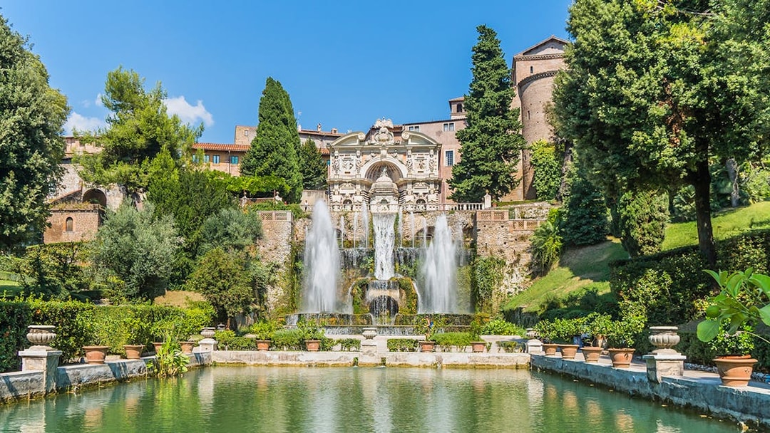 Fountain and gardens at Villa d'Este in Tivoli, Italy, with cascading water and lush greenery.