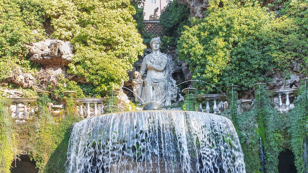 Villa d'Este fountain with cascading water and statue in Tivoli, Italy.