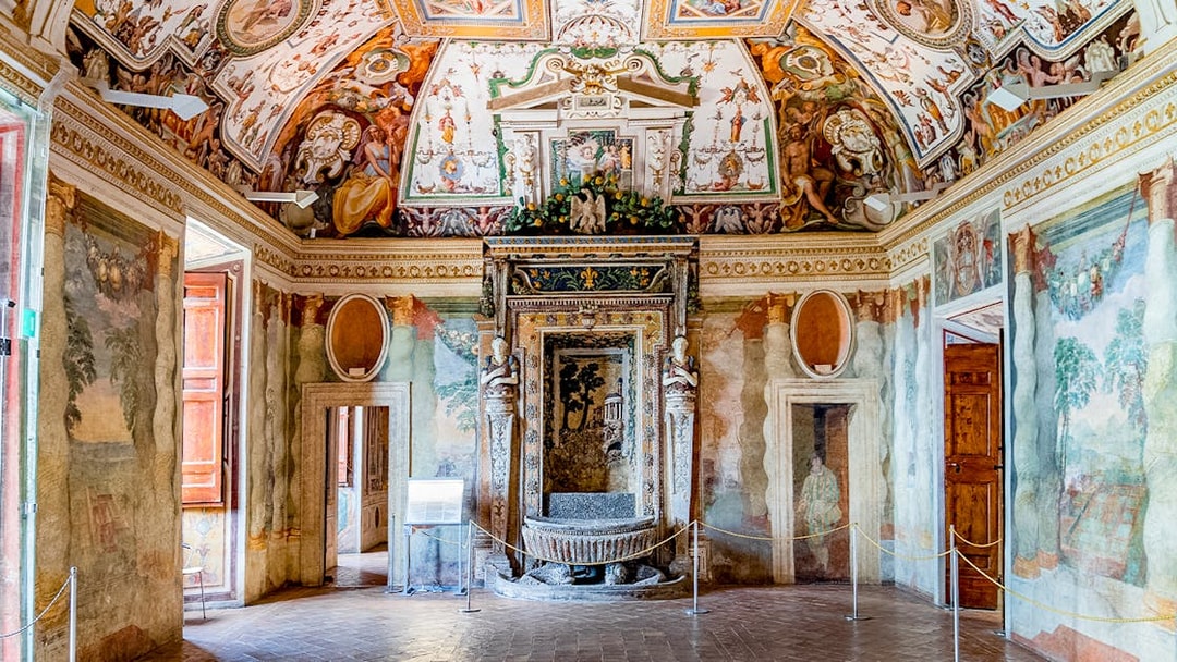 Villa d’Este interior with ornate frescoes and detailed ceiling in Tivoli, Italy.