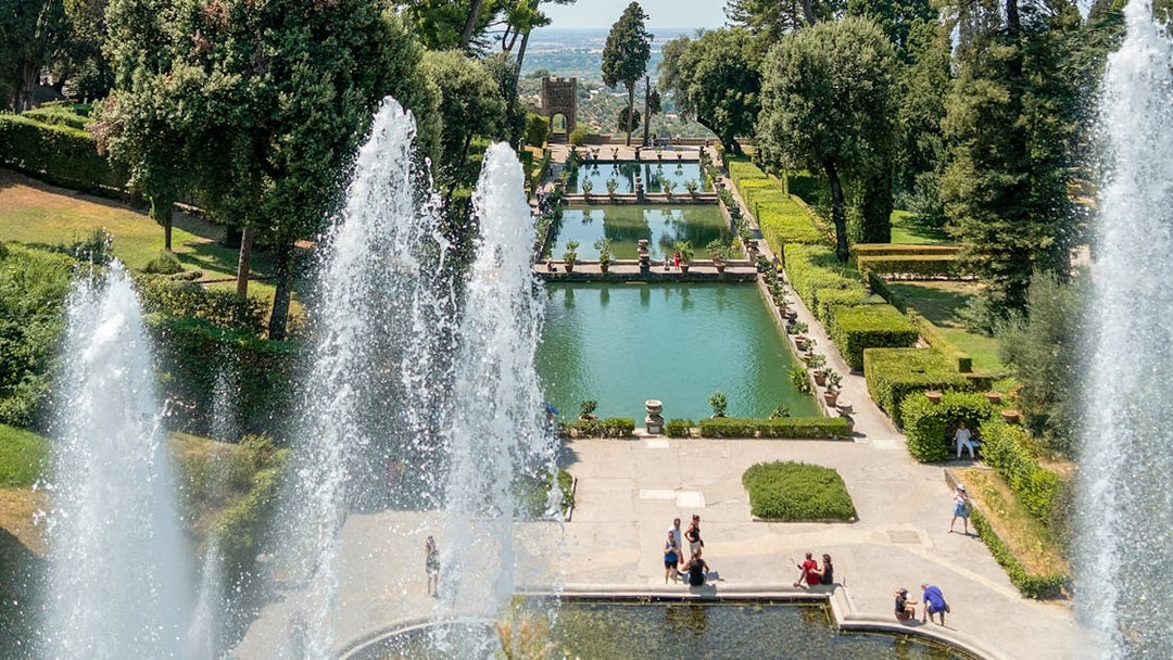 Tourists enjoying the fountains and gardens of Villa d'Este in Tivoli, Italy.