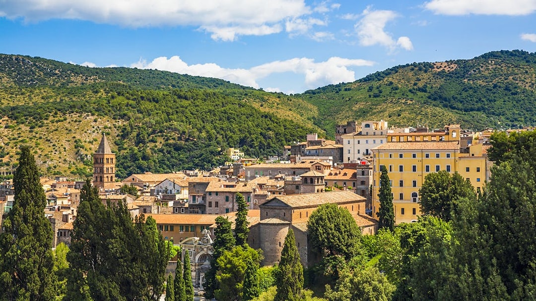 Tivoli townscape with lush greenery near Villa d'Este gardens, Italy.
