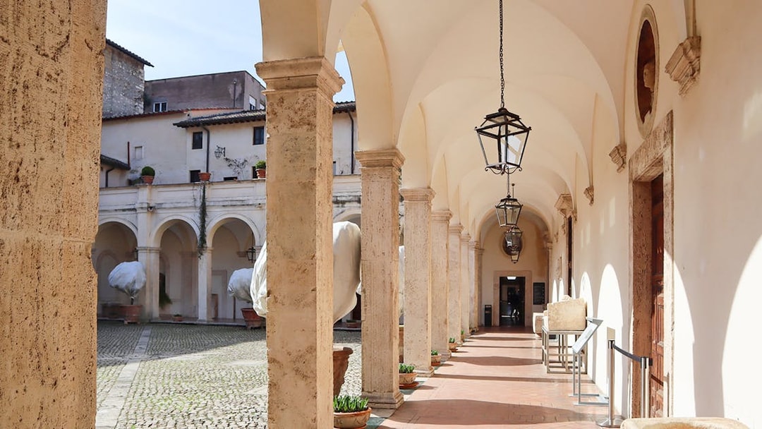 Patio with arches and lanterns at Villa d'Este in Tivoli, Italy.