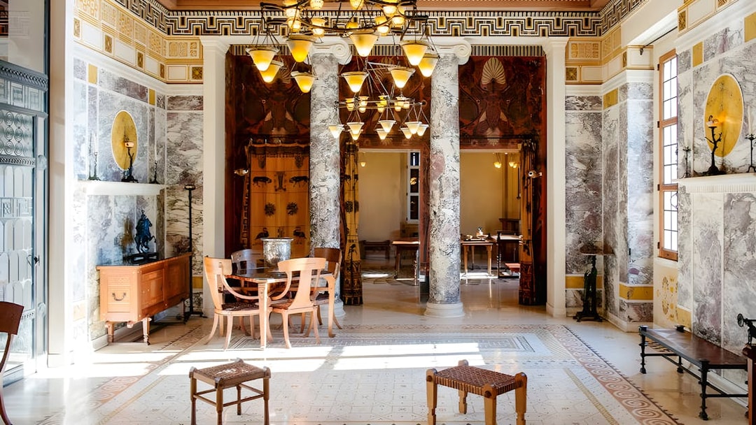 Villa Kerylos interior with marble columns and decorative Greek motifs.