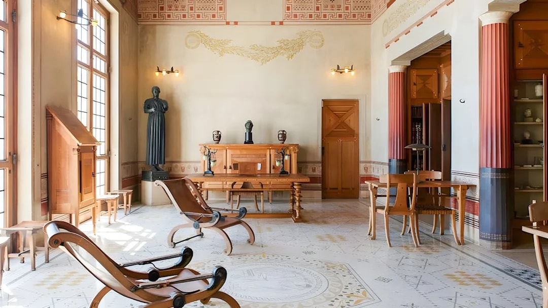 Villa Kerylos interior with Greek-style decor and wooden furniture in Beaulieu-sur-Mer, France.