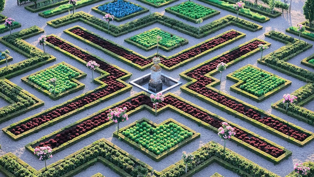 Maze Garden at Château of Villandry with geometric hedges and colorful flower beds.