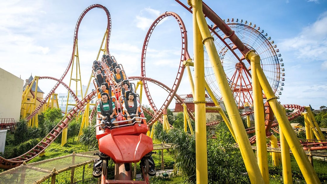 Roller coaster and Ferris wheel at VinWonders Phu Quoc theme park.