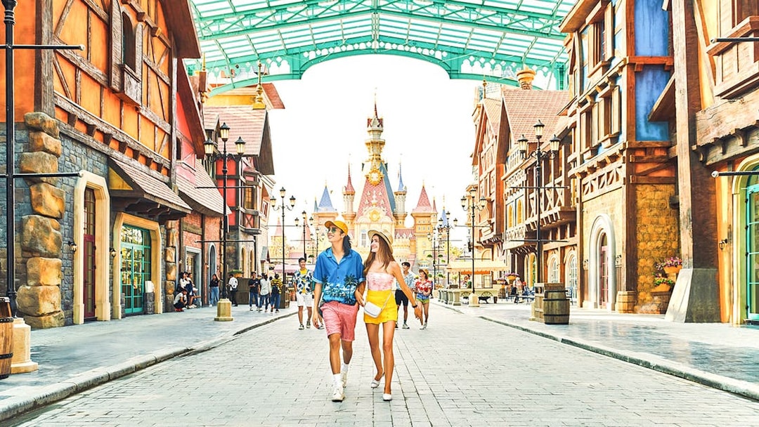 Guests walking through VinWonders theme park with castle in background.