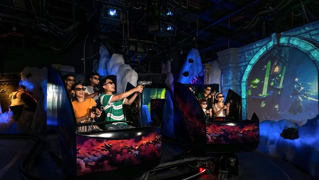 Visitors enjoying VR games at VinWonders in a themed indoor ride.