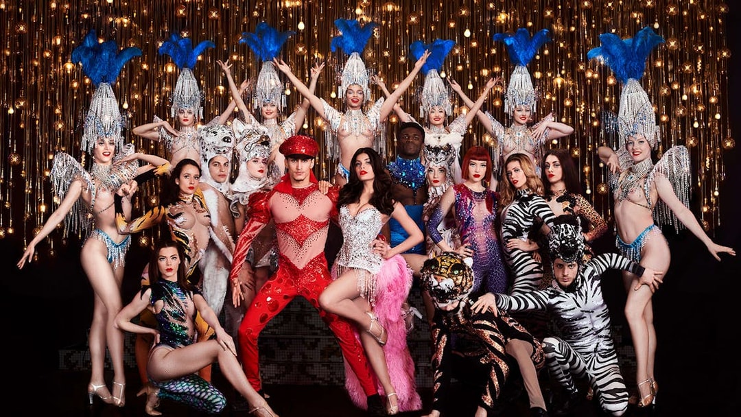 Performers in vibrant costumes at Paradis Latin cabaret show, Soirée Napoléon, Paris.